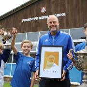 Head of PE Simon Higgins and some of his school’s silverware