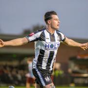 Will Fletcher celebrates scoring Wimborne's 3rd goal.