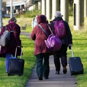 Passengers at Gatwick airport near Crawley, West Sussex (Gareth Fuller/PA)