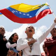 Opposition leader Maria Corina Machado waves a Venezuelan national flag (AP)