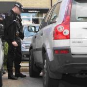 hunt: Armed police officers respond to a report of a damaged Volvo XC90 at the Village Hotel car park in Bournemouth, inset Jade (back) with her brothers and sisters William, 12, Rachel, 9, Danni, 2, and Tommy eight months