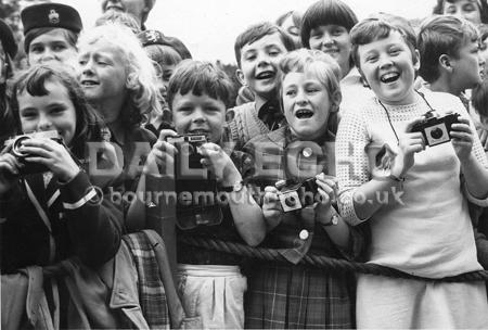  Christchurch Queen visit.  Children  wait  to see the  queen  cameras at the ready. 