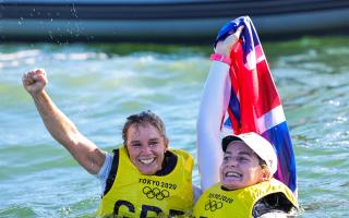 Hannah Mills, left, and Eilidh McIntyre celebrate in the water after winning gold at Tokyo 2020 Picture: SAILING ENERGY/WORLD SAILING