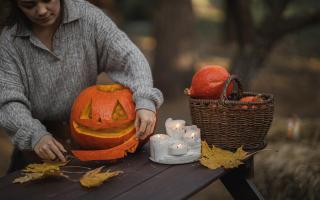 A child carving a pumpkin. Credit: Monstera from Pexels