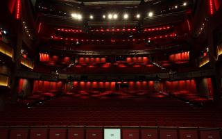 Rows of empty red theatre seats. Credit: PA