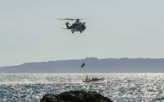 Emergency services airlift an injured person off the beach at Man O’War Bay at Durdle Door.