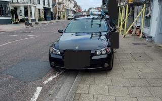 BMW parked on white zig zag lines