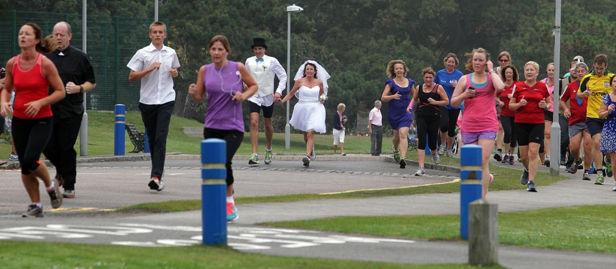 Keen runners Eve Carter and Graham Filmer tie the knot during the Poole parkrun. Photos by Sally Adams. 