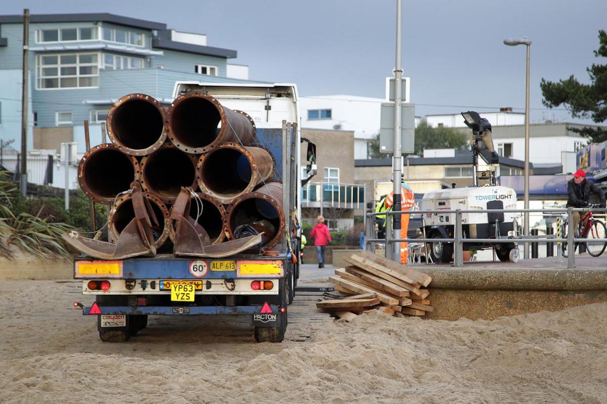 The 700m pipe used to protect Poole's beaches from coastal erosion after the winter storms is removed from Canford Cliffs. Photos by Sally Adams. 