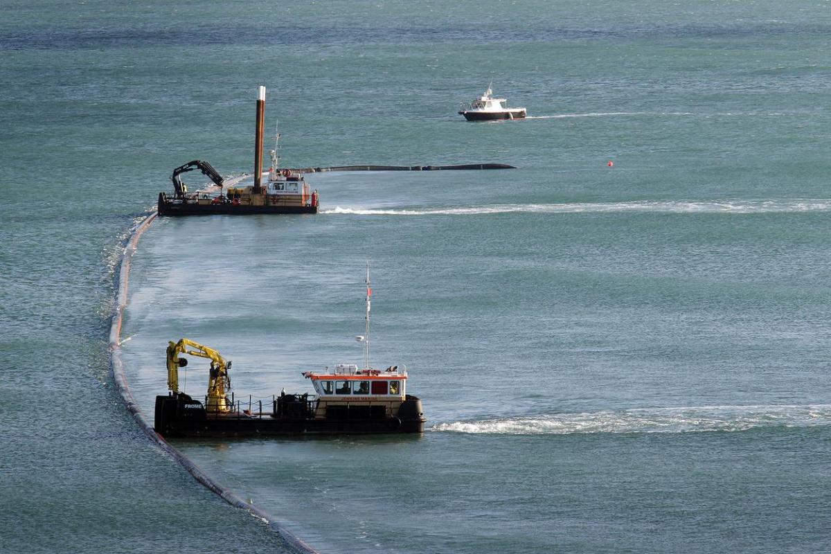 The 700m pipe used to protect Poole's beaches from coastal erosion after the winter storms is removed from Canford Cliffs. Photos by Sally Adams. 