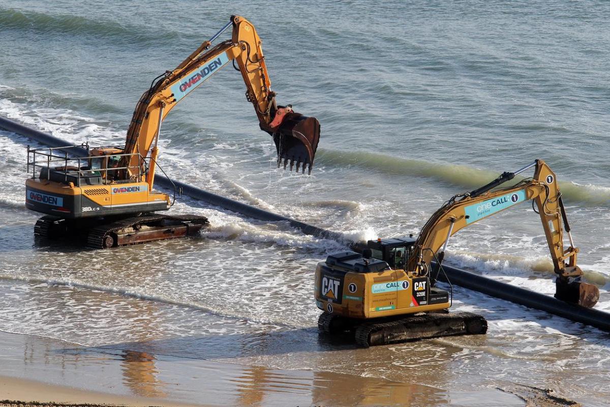 The 700m pipe used to protect Poole's beaches from coastal erosion after the winter storms is removed from Canford Cliffs. Photos by Sally Adams. 